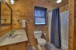 Main floor bathroom with a large shower stall and laundry room 